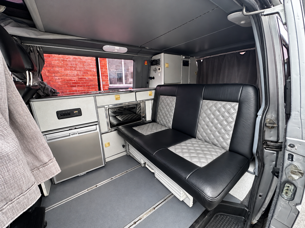 Reimo camper interior with rock and roll bed