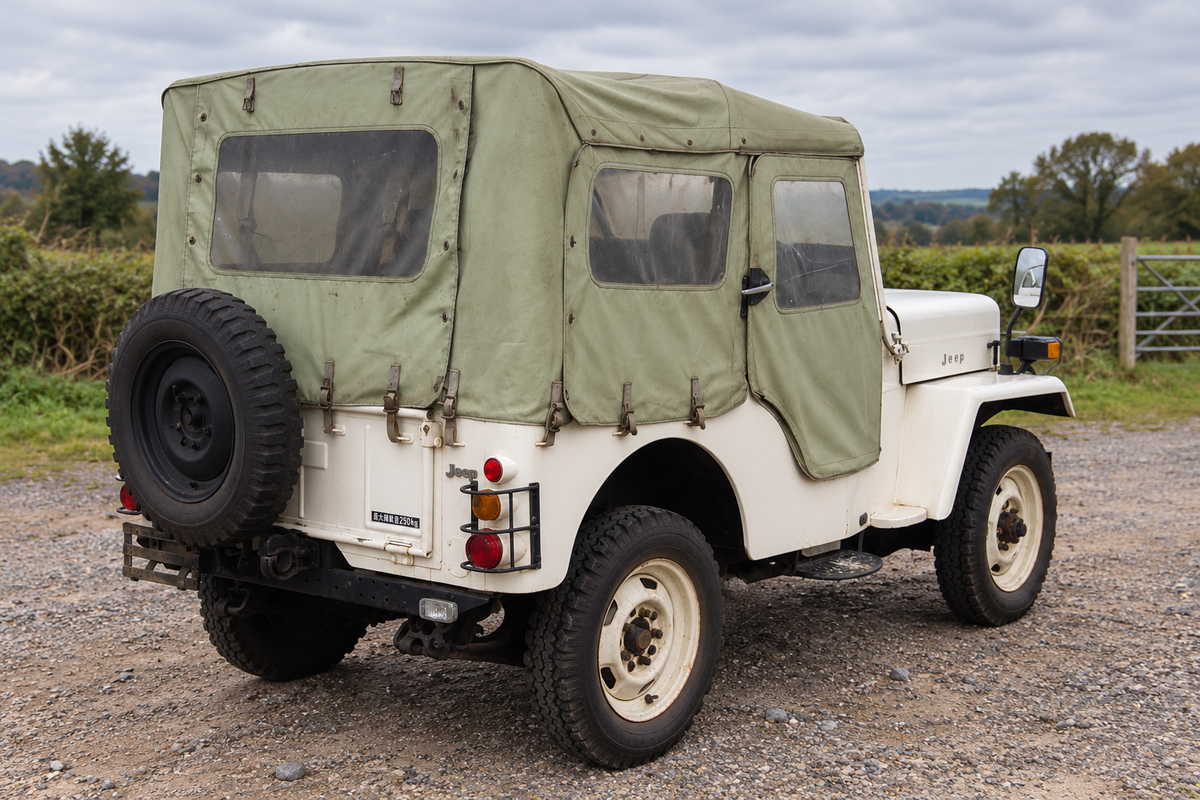 1976 Mitsubishi Jeep J54 rear three-quarter with canvas hood and spare wheel